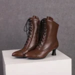 Steampunk Victorian brown leather lace-up ankle boots with metal eyelets and kitten heel - front studio view