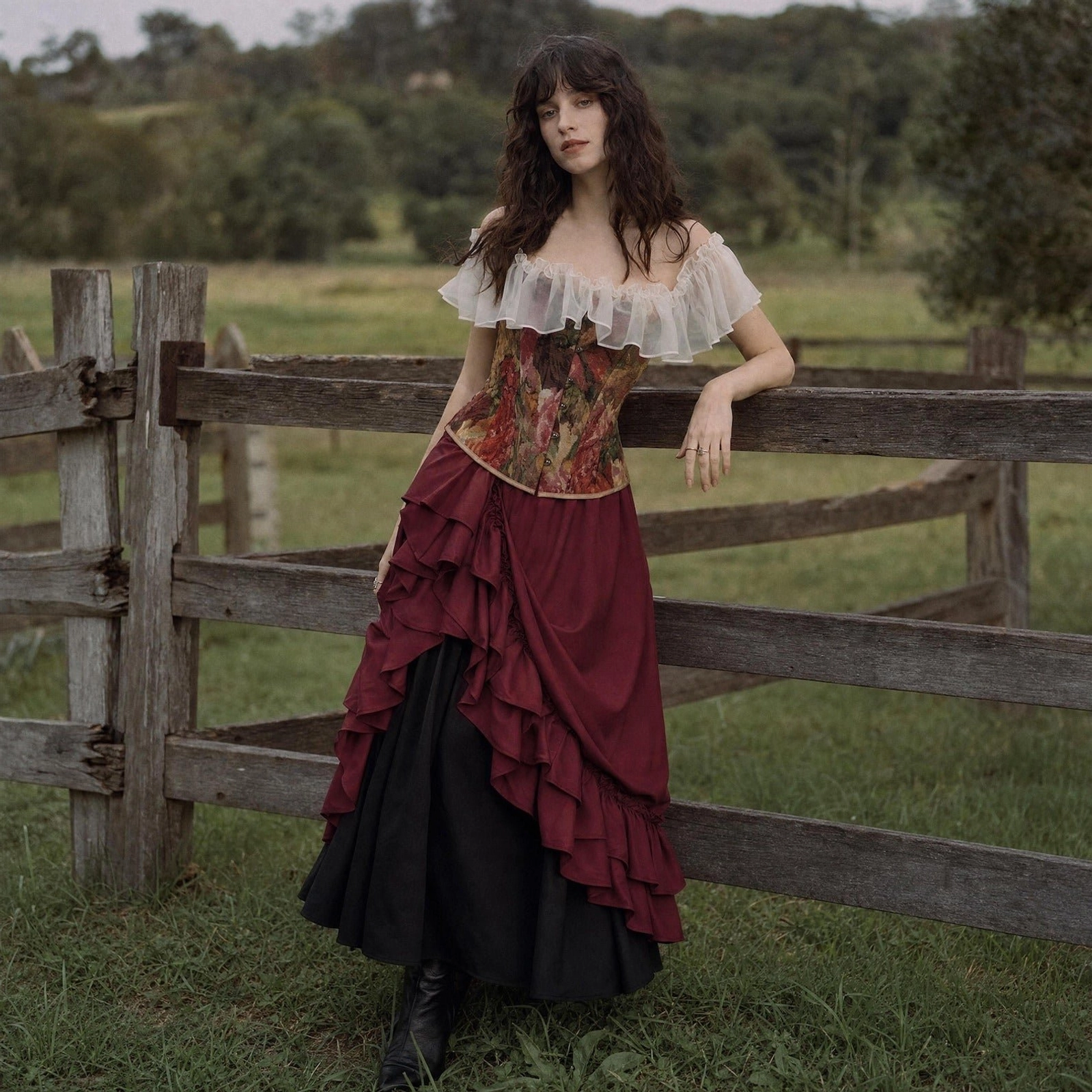 Steampunk Victorian long maxi skirt with layered ruffled front design, two-tone color blocking, high-waist construction, worn by female model outdoors