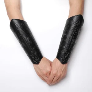 Black steampunk Viking arm guard with intricate rune engravings and Celtic tribal patterns displayed on human forearms, front view against white background showing dimensional embossed details