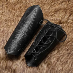 Pair of black faux leather steampunk arm guards featuring lace-up closure system and embossed vintage Norse designs, overhead angle on brown fur background showcasing mounting eyelets and material texture