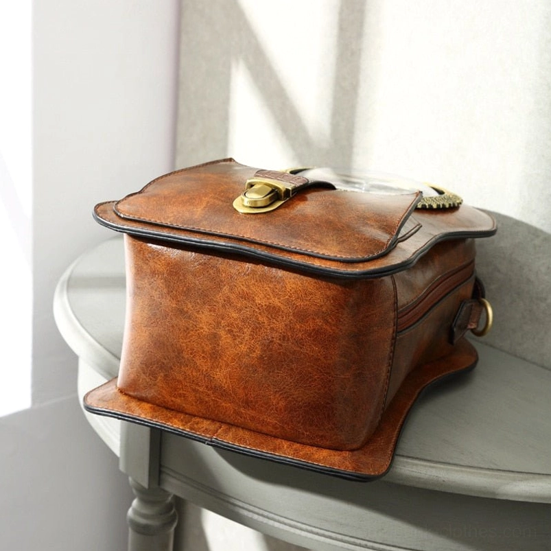 Closed steampunk clock crossbody bag showcasing structured vintage brown leather, brass lock closure mechanism, and front flap design