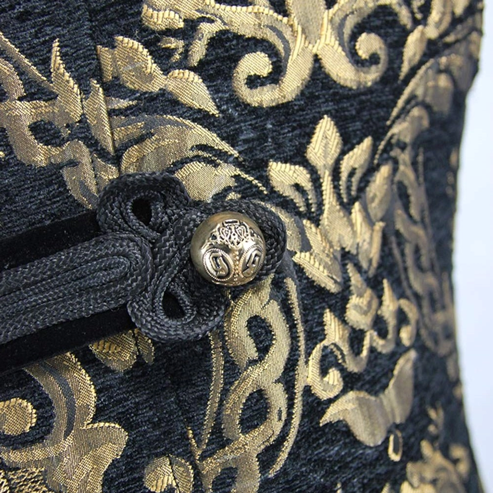 Black velvet fabric with gold damask embroidery and vintage metal button fastener macro detail