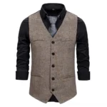 Men's steampunk waistcoat front full view showing brown herringbone fabric with button closure, pocket flaps and decorative gold chain detail on mannequin display