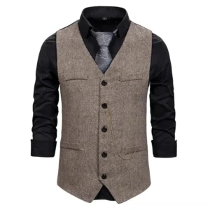 Men's steampunk waistcoat front full view showing brown herringbone fabric with button closure, pocket flaps and decorative gold chain detail on mannequin display
