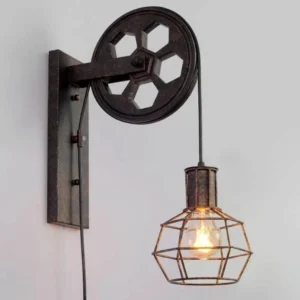 Industrial steampunk wall lamp featuring hexagonal pulley mechanism, matte aged black metal finish, and exposed hanging wire, shown in flat front perspective against white studio background