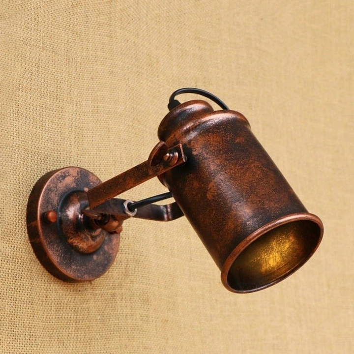 Single-head steampunk wall lamp, side three-quarter angle showcasing distressed bronze iron construction and adjustable mounting joint mechanism