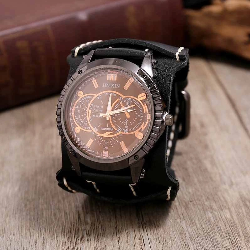 Black leather steampunk wristwatch with gun-black metal case and copper-toned dial details on retro wooden surface