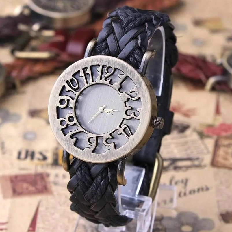 Black braided leather steampunk watch with bronze metal case, vintage-style hollowed numbers, flat lay composition on newspaper background