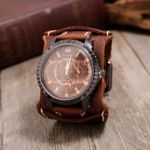 Steampunk leather wristwatch with brown genuine cowhide strap, gunmetal case, and copper-toned subdials on vintage wooden desk with antique books