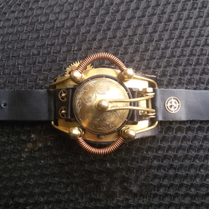 Steampunk enclosed wristwatch with brass protective cover, copper coil embellishments, mechanical gears, and compass emblem leather strap, front top view