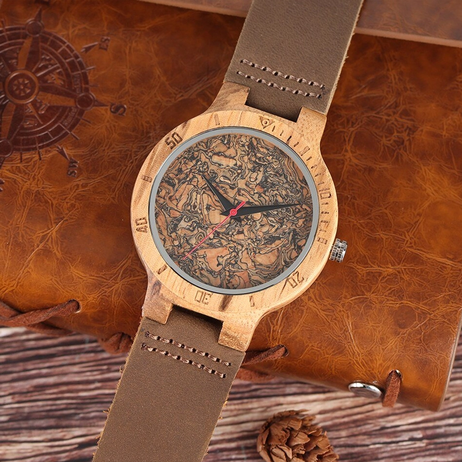 Top-down left view of cork wood watch showing engraved text on leather strap and crown mechanism