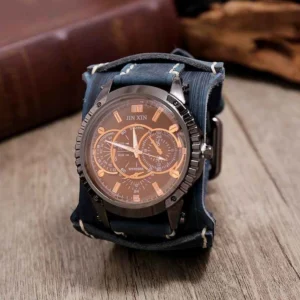 Navy blue steampunk leather watch with gunmetal bezel, brown copper-accented dial, white topstitching on vintage tabletop setting