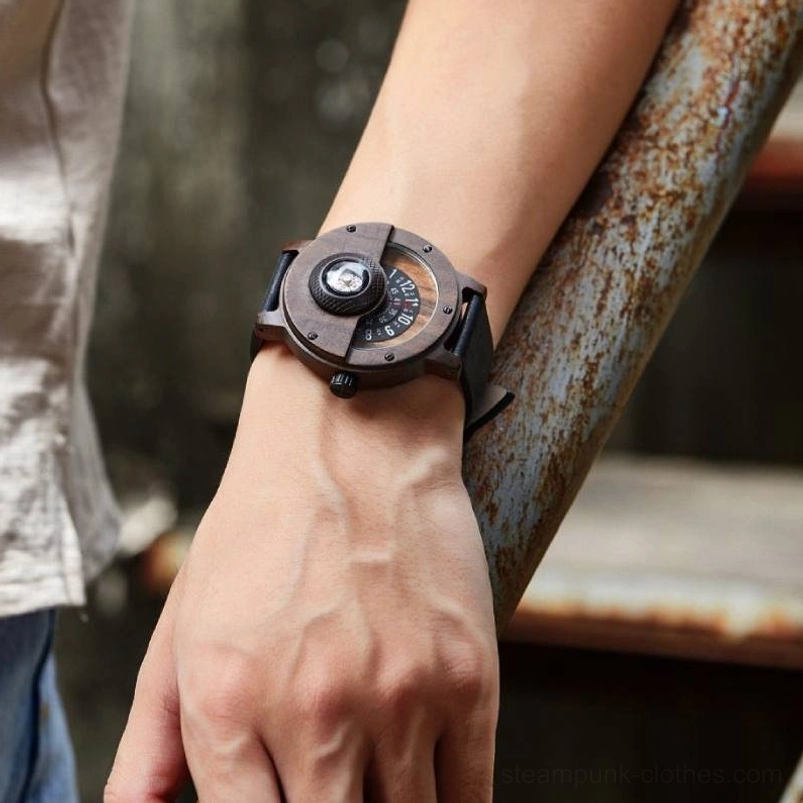 Steampunk wooden watch worn on male wrist showing dark brown wood case and black leather strap