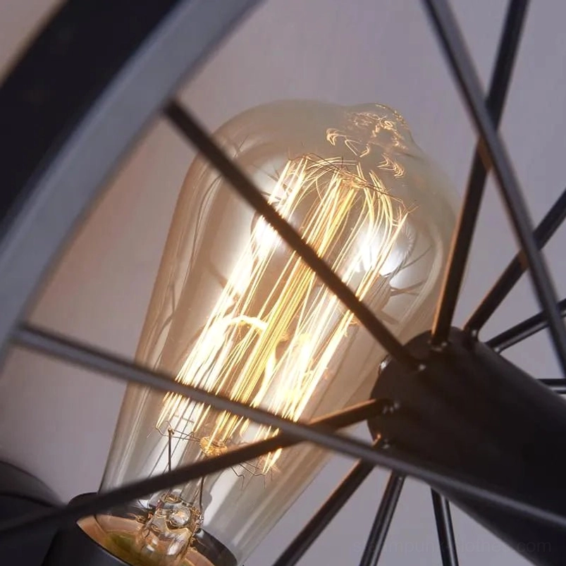 Close-up of steampunk wheel lamp bulb and black metal spokes, showing Edison filament bulb detail and lamp structure engineering