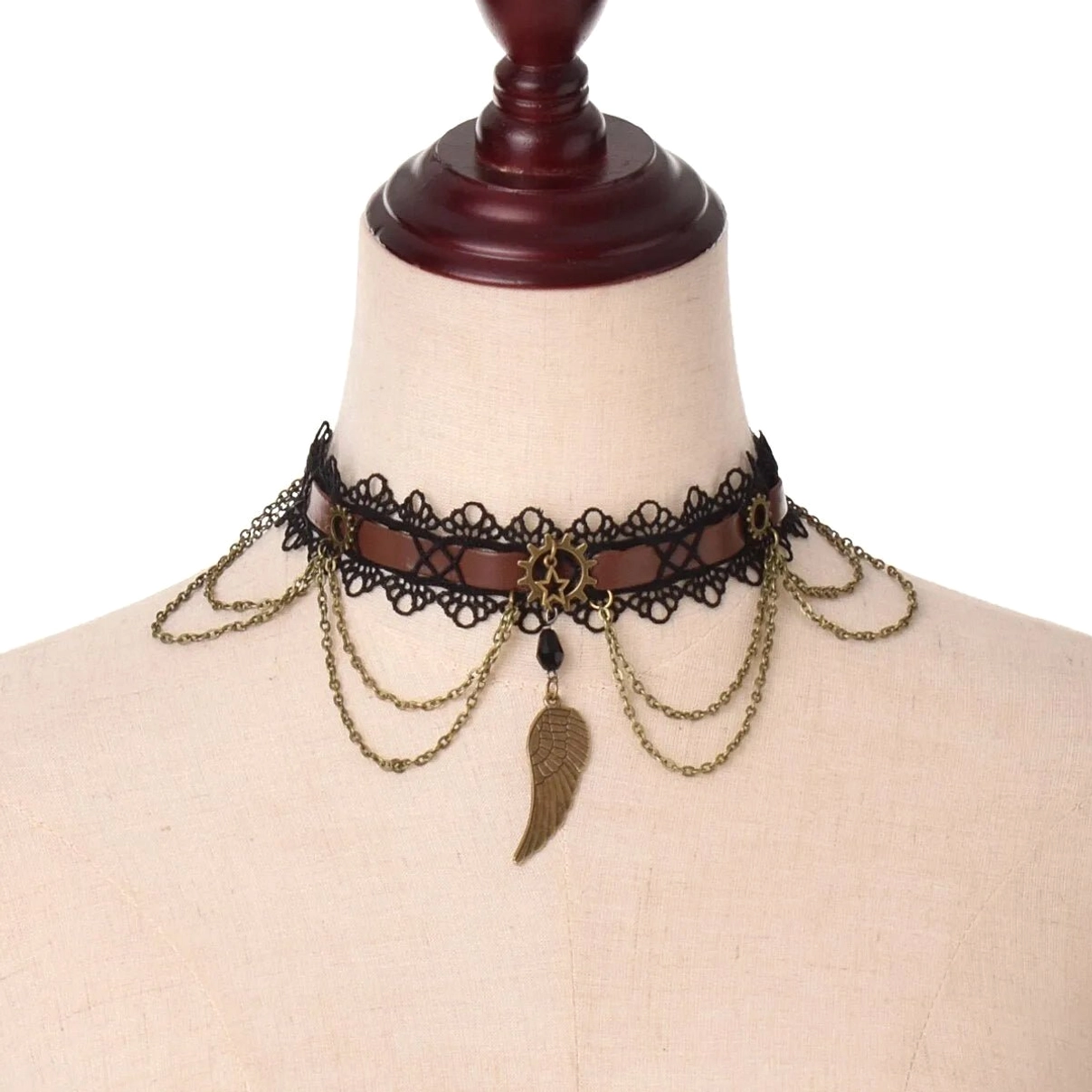 Steampunk wing lace choker necklace front view with bronze wing pendant and layered chains on fabric mannequin