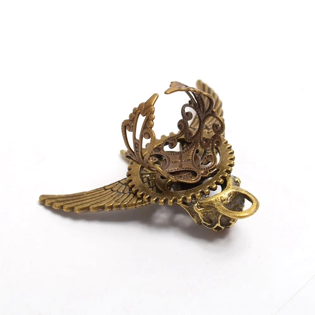Rear side view of steampunk winged skull ring displaying hollow carved gear structure and bronze finish