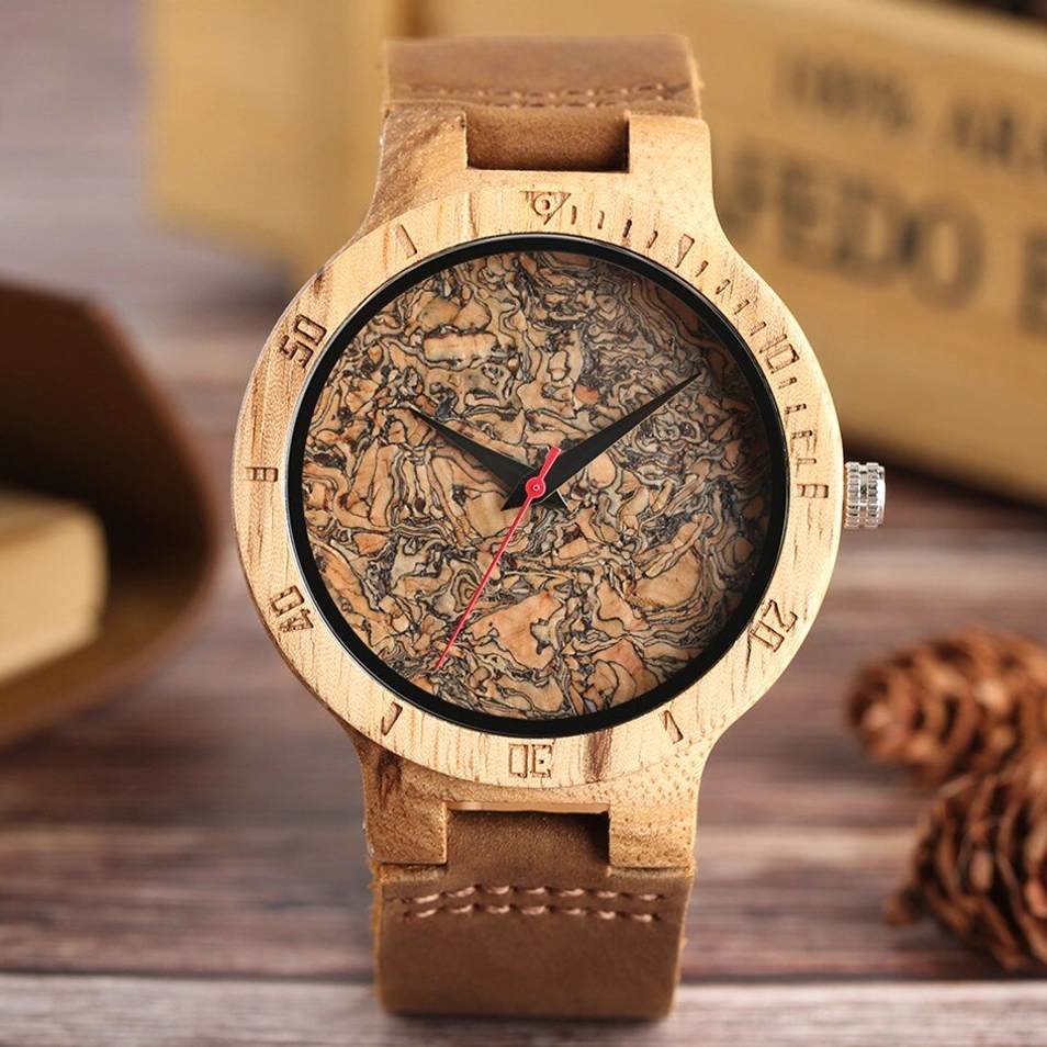 Front view of wooden quartz steampunk watch with stitched leather strap and engraved scale bezel on wooden desk