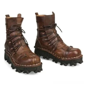 Distressed brown leather steampunk work boots front three-quarter view with chunky serrated rubber outsole and lace-up design on white background