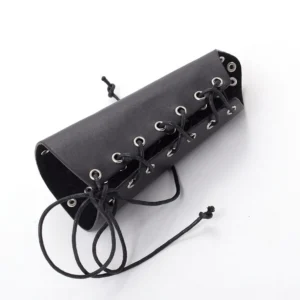 Black PU leather wrist guard with metal eyelets and adjustable drawstring lace-up fastening system, angled top-down flat lay view