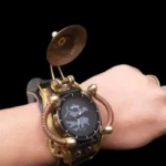 Steampunk mechanical wristwatch with exposed gears and brass components, worn on left hand with vintage ring, displaying oblique side view of copper coil detailing against dark background
