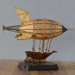 Steampunk zeppelin model with aged brass details and metal mesh gasbag displayed on wooden surface with vintage decor backdrop