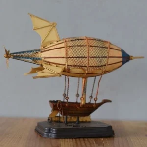 Steampunk zeppelin model with aged brass details and metal mesh gasbag displayed on wooden surface with vintage decor backdrop