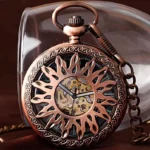 Sunburst skeleton steampunk pocket watch with carved floral copper case front close-up view