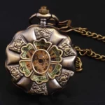 Sunflower steampunk pocket watch back view showing scalloped floral case with embossed botanical decoration and clover-style skeleton movement in bronze tone