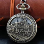 Steampunk pocket watch front view featuring intricate hollow steam train relief engraving, bronze-tone stainless steel case with diamond-patterned frame edge, Victorian-era inspired design