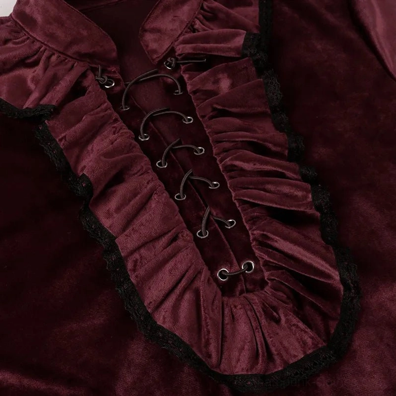 Close-up detail of burgundy velvet blouse collar showing black lace trim and metal eyelet fasteners