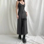 Verdy steampunk gothic maxi dress front three-quarter view with silver eyelet trim, V-neck lace-up detail, and asymmetrical seam design on model wearing platform combat boots