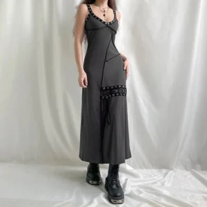 Verdy steampunk gothic maxi dress front three-quarter view with silver eyelet trim, V-neck lace-up detail, and asymmetrical seam design on model wearing platform combat boots