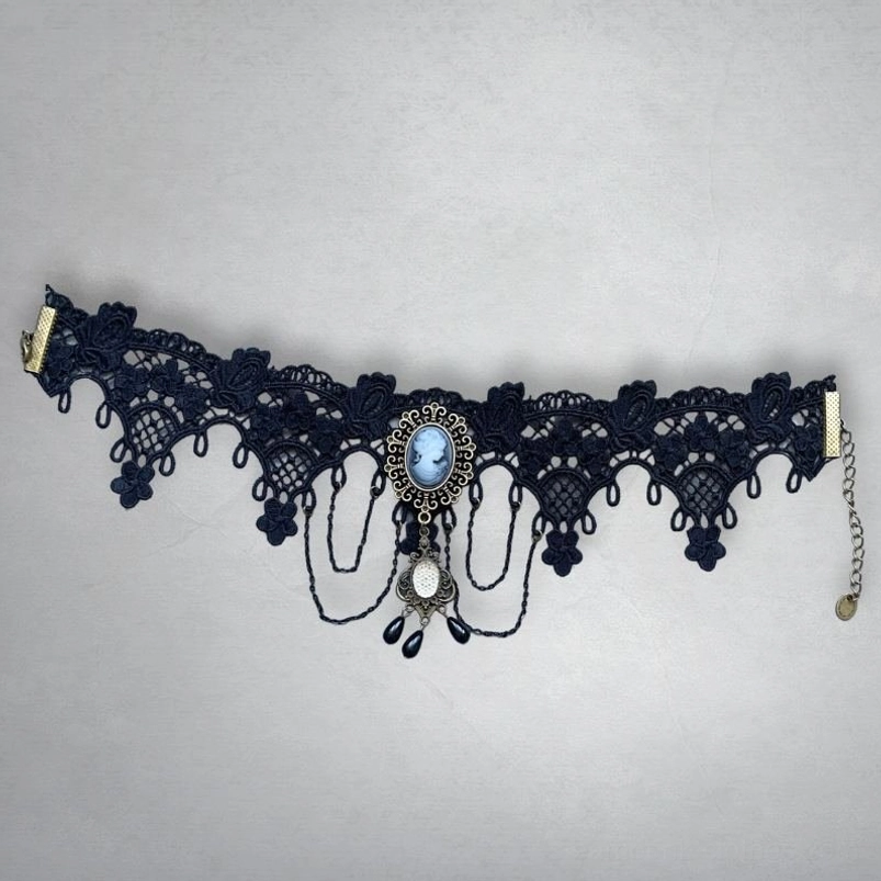 Victorian cameo lace choker unworn, featuring dark navy lace, small portrait cameo pendant, thin dangling chains and tiny black beads - flat lay studio view
