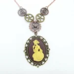 Victorian cameo steampunk necklace with mixed metal gears and bronze filigree frame, rose gold chain displayed on white background