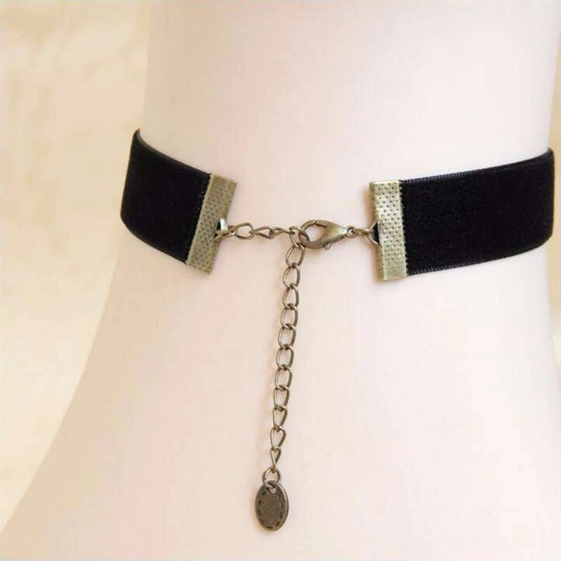 Steampunk choker hardware components including bronze end caps, lobster clasp, and extendable adjustment chain with brand tag on light background