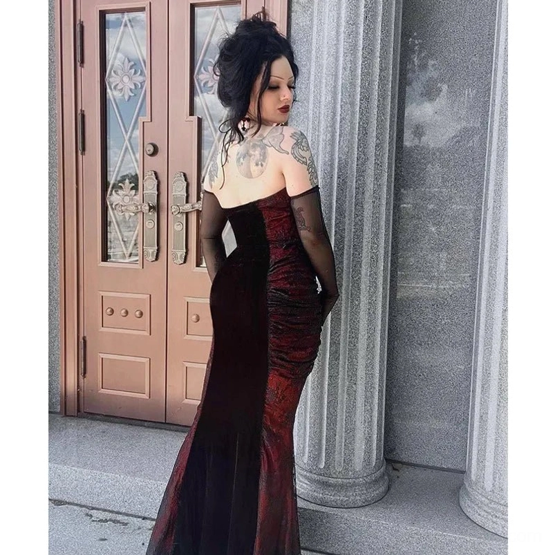 Victorian mermaid dress side profile view, red velvet panels, backless strapless cut, long black gloves, elegant silhouette against vintage stone building entrance