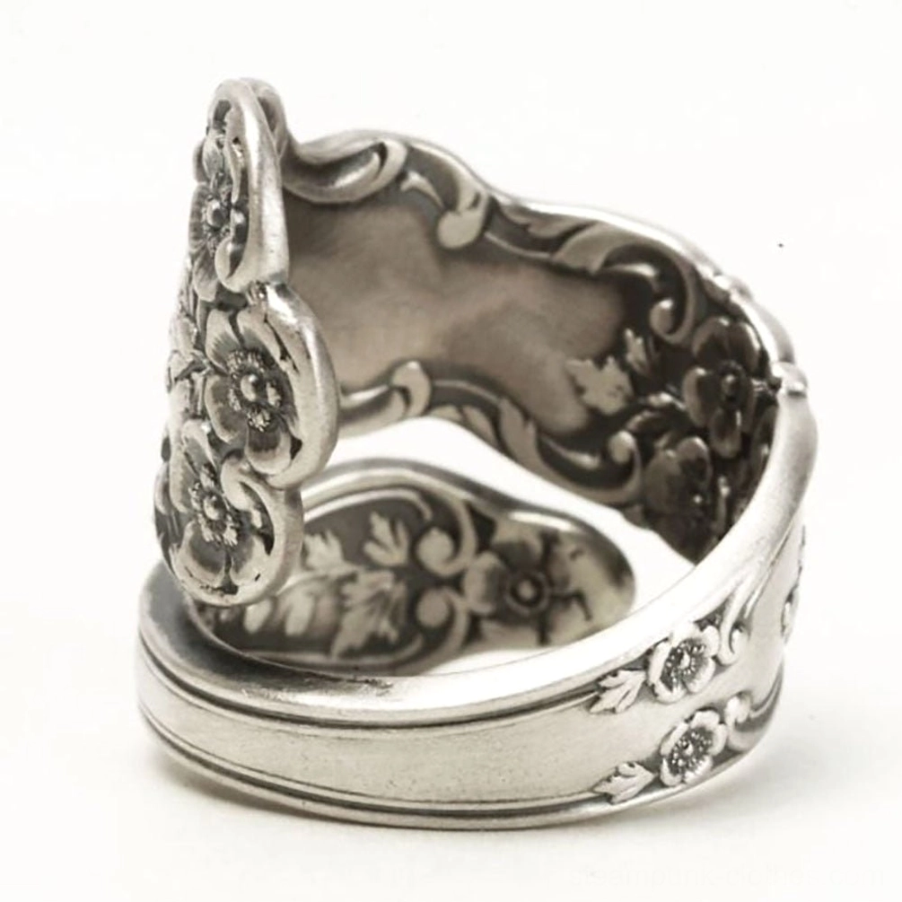 Victorian floral engraved adjustable silver ring rear three-quarter angle view displaying back side decorative patterns and consistent relief carvings