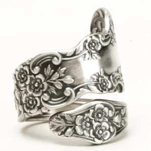 Victorian floral engraved adjustable silver ring left three-quarter angle view showing detailed relief carved flowers and vine motifs in antique silver finish