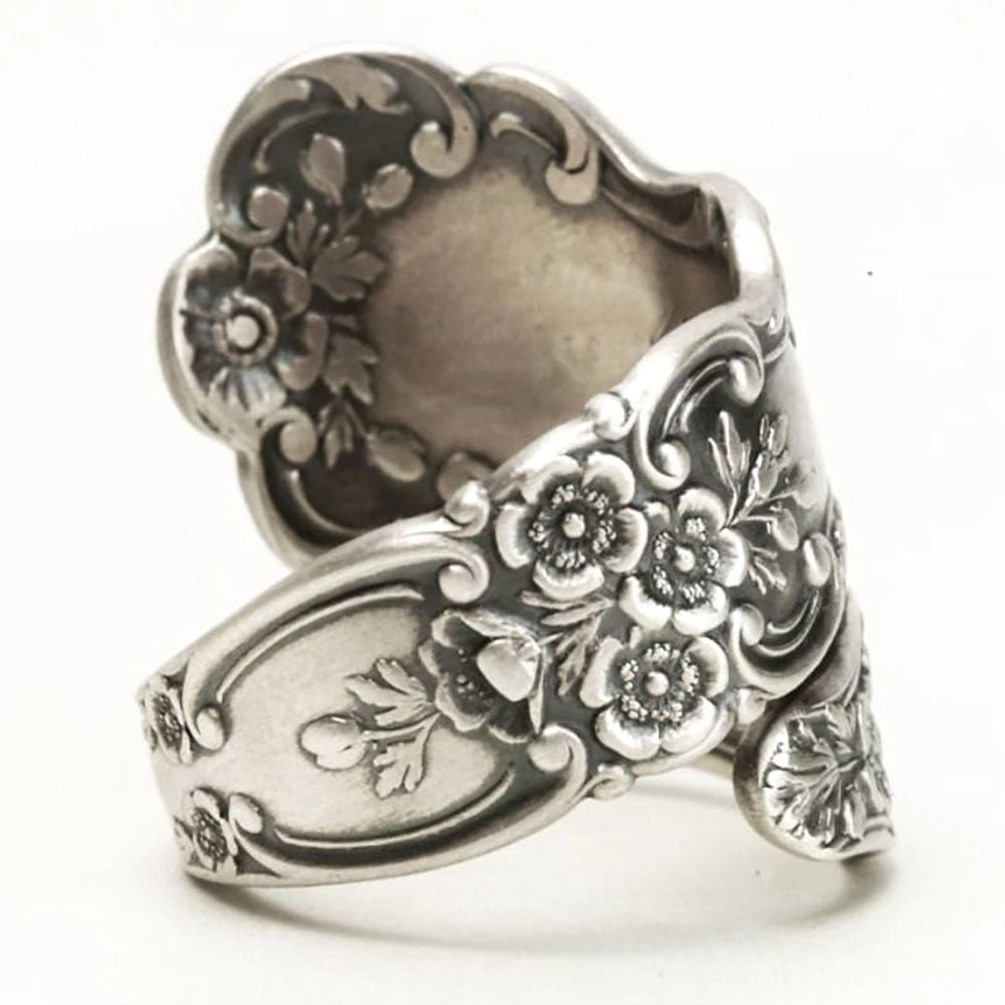 Victorian floral engraved ring right top three-quarter angle showcasing hollow center construction and detailed botanical engravings throughout the band