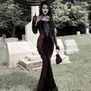 Black red Victorian strapless mermaid dress front view, worn by tattooed woman with long black hair in gothic cemetery setting, featuring lace bust trim, velvet panels, and matching long gloves
