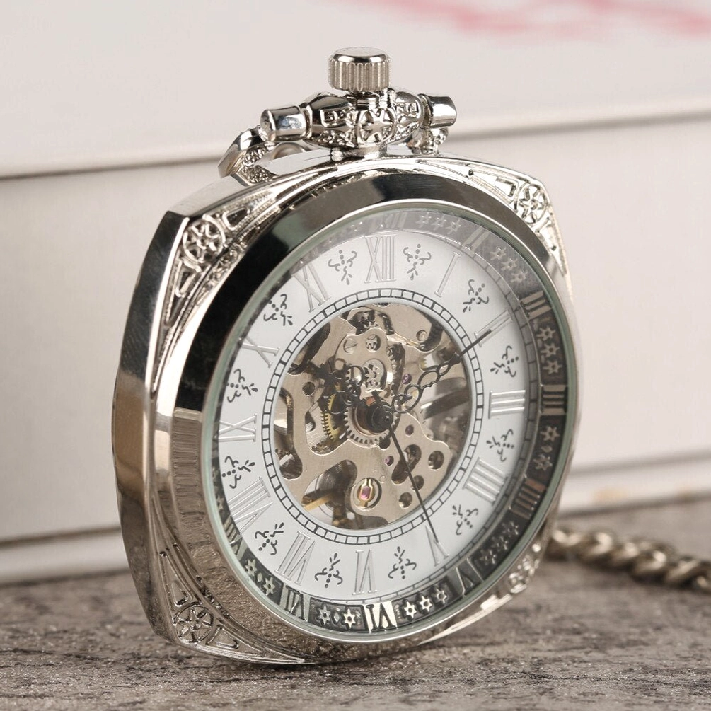 Mechanical steampunk pocket watch three-quarter side view showing ornate silver casing and transparent crystal dial with visible internal gears