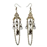 Victorian steampunk chandelier earrings with antiqued brass filigree, imitation pearl beads, chain tassels, and flower charms on white background