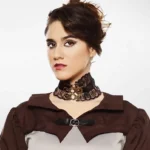Victorian steampunk choker with bronze gears and clock charms on model - front half-body studio view