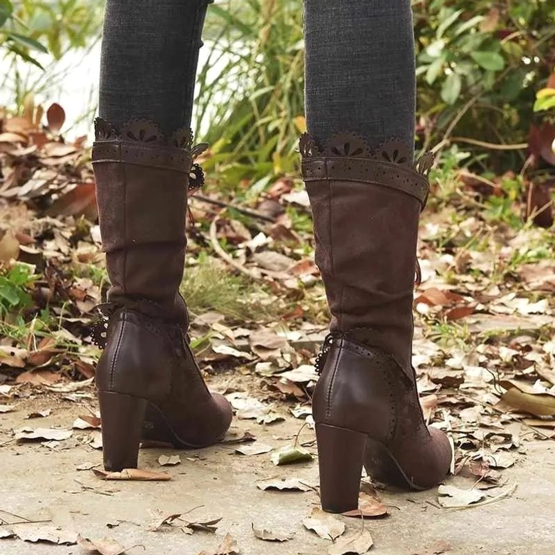 Rear view of dark brown steampunk mid-calf heeled boots showing scalloped collar trim and block heel construction