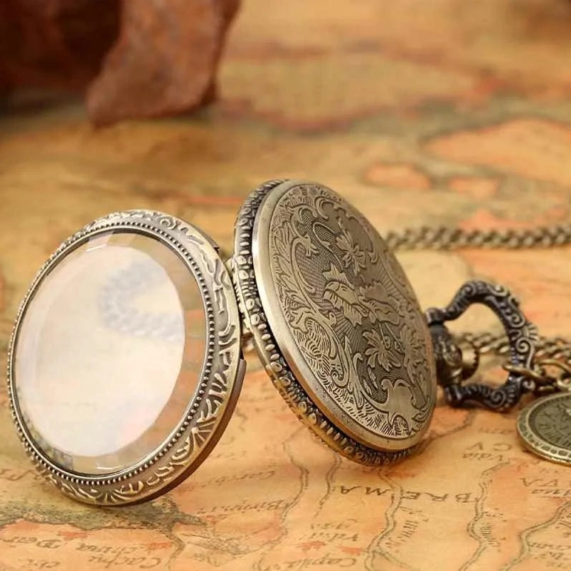 Hinged vintage pocket watch case in bronze tone with carved details and open mechanical cover, positioned on antique map background