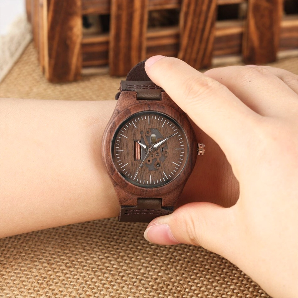 Wearing wooden skeleton steampunk watch on wrist showing natural wood texture, fitted genuine leather strap in action