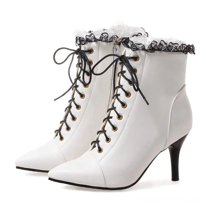 Pair of white steampunk Victorian lace-up heeled ankle boots featuring black ruffled lace collar, gold-toned eyelets, black laces, and stiletto heel - front three-quarter studio view