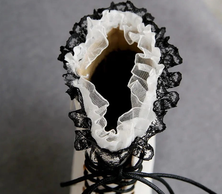 Close-up interior top-down view of white Victorian steampunk boot showing dual-layer lace ruffles, soft fleece lining, and front lace-up design