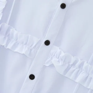 Black button placket close-up detail of white Victorian steampunk shirt showing ruffled trim and stitching
