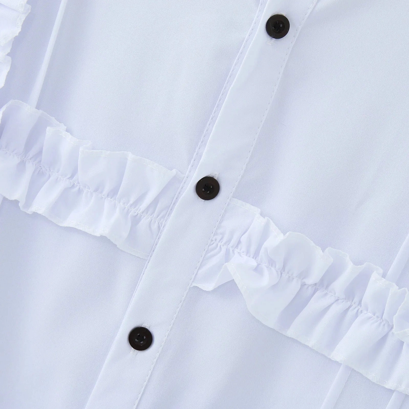 Black button placket close-up detail of white Victorian steampunk shirt showing ruffled trim and stitching